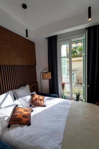 une chambre avec un grand lit avec deux oreillers dessus dans l'établissement Superbe studio Plage/Promenade des Anglais 105, à Nice