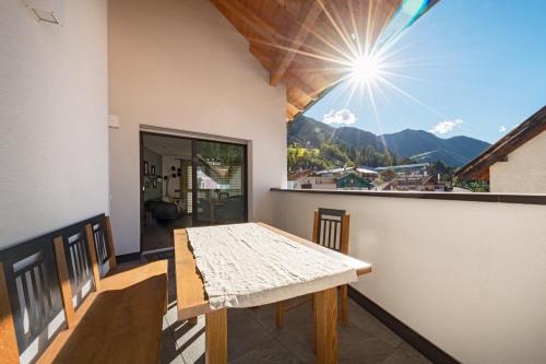 a room with a table and a view of a mountain at Central Home Apartment in Ortisei