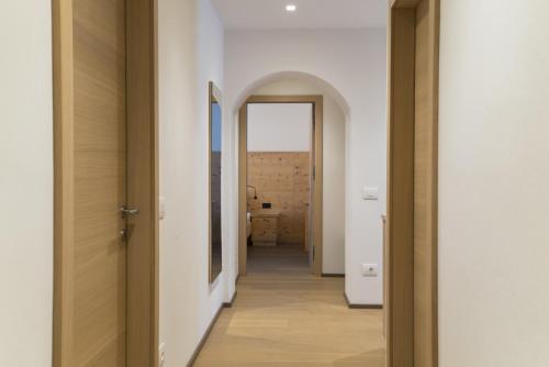 a hallway leading to a room with a mirror at Apartments Jalve in Ortisei