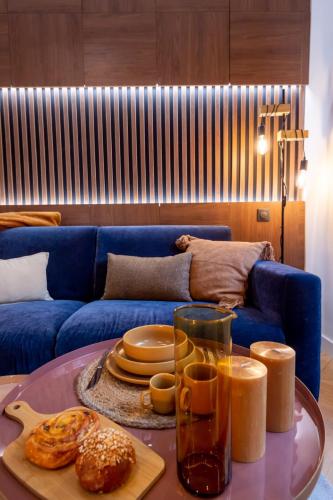 - un salon avec un canapé bleu et une table avec de la nourriture dans l'établissement Superbe studio balcon Plage/ Prom. des Anglais 103, à Nice