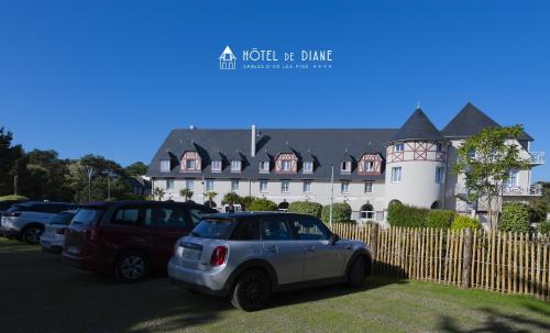 a white car parked in front of a building at Hotel De Diane in Sables-dʼOr-les-Pins