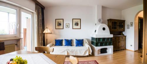 a bedroom with a bed with blue pillows and a fireplace at Apartment Matilde in Vols am Schlern
