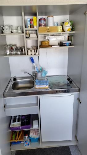 a small kitchen with a sink and a counter at Sonnendeich in Norddeich