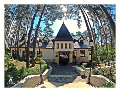 a large house with a black roof at Complex Parc Pini Moinesti in Moineşti