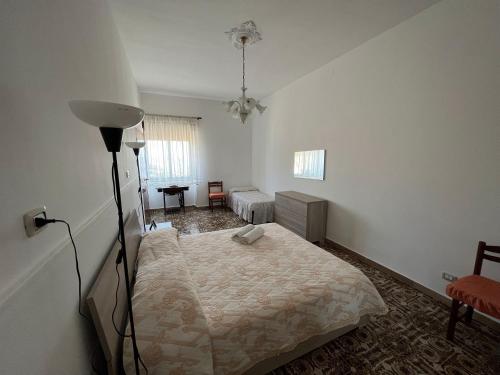 Un dormitorio con una cama y una lámpara. en La Dimora di Eloisa, en Castel di Iudica