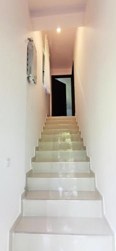 a stairway with white stairs in a building at Complex Parc Pini Moinesti in Moineşti