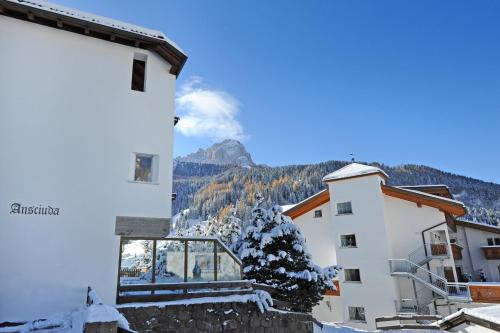 a view of the mountains from the balcony of a building at Apartment Nogler Frieda in Selva di Val Gardena