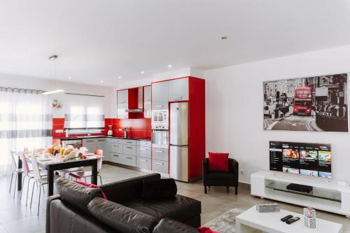 a kitchen and living room with a couch and a table at Barrocas Village in Olho Marinho
