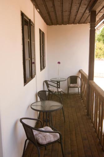 a patio with tables and chairs on a porch at Penzion Marcipánka in Třeboň