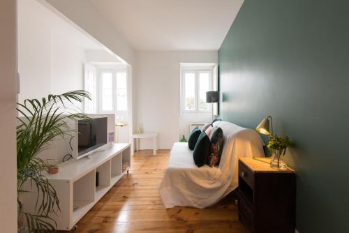 a bedroom with a bed and a tv in it at CASASUPERTUBOS® Apart 9-14 in Peniche