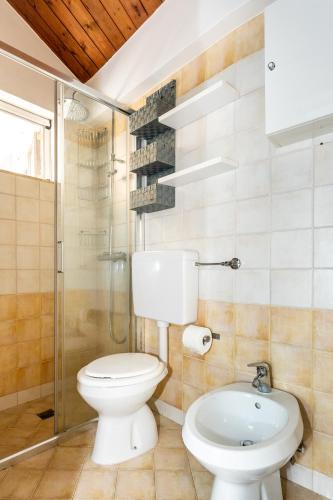 a bathroom with a toilet and a shower and a sink at ConVivo Apartment in Lecce