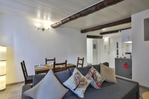 un salon avec un canapé bleu avec des oreillers dans l'établissement Jolie 2 pièces quartier Bonaparte/ Clim, à Nice