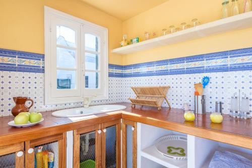 a bathroom with a sink and a window at Brisa Marina in Cala en Blanes