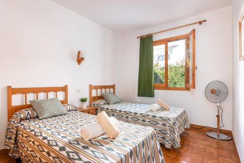 a bedroom with two beds and a window at Brisa Mar 2, 2 bedroom apartment, Cala'n Bosch in Son Xoriguer