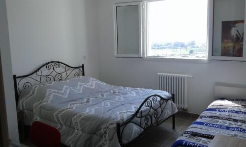 a bedroom with a bed and a window at Bella Vista 2A in Ajaccio