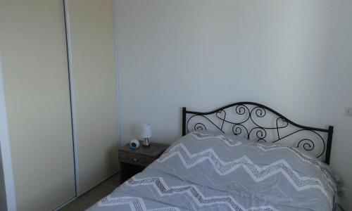 a bedroom with a bed with a black and white comforter at Bella Vista 2A in Ajaccio