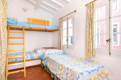 a bedroom with two bunk beds and a ladder at SA FONT in Ciutadella
