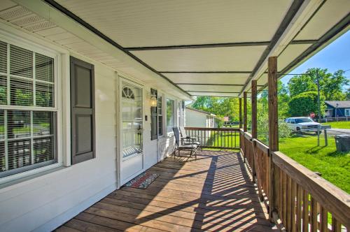 a porch of a house with a chair on it at Dog-Friendly Fayetteville Home with Hot Tub! in Fayetteville