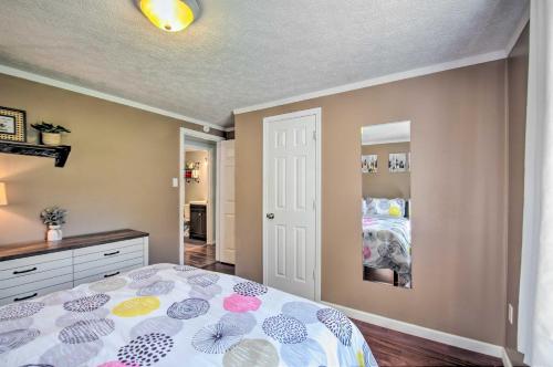 a bedroom with a bed and a dresser at Dog-Friendly Fayetteville Home with Hot Tub! in Fayetteville
