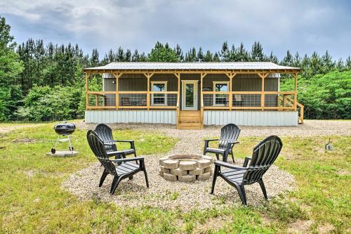 a group of chairs sitting in front of a house at Broken Bow Cabin on 15 Acres with Stocked Fish Pond! in Broken Bow