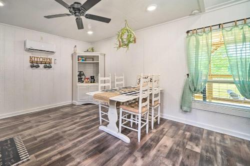 a dining room with a table and chairs and a ceiling fan at Broken Bow Cabin on 15 Acres with Stocked Fish Pond! in Broken Bow