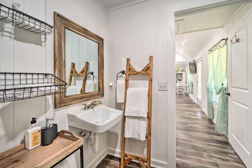 a bathroom with a sink and a mirror at Broken Bow Cabin on 15 Acres with Stocked Fish Pond! in Broken Bow