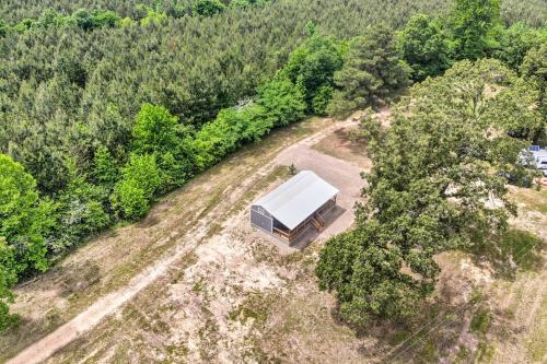 an overhead view of a house in the middle of a forest at Broken Bow Cabin on 15 Acres with Stocked Fish Pond! in Broken Bow