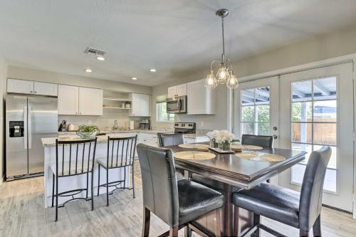 a kitchen and dining room with a table and chairs at 3 Mi to ASU! Snowbird Poolside Escape in Tempe in Tempe