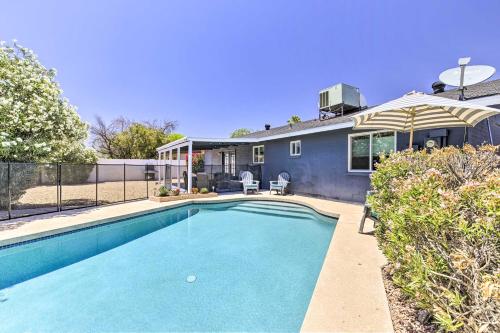 a swimming pool in front of a house at 3 Mi to ASU! Snowbird Poolside Escape in Tempe in Tempe