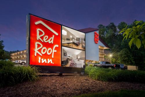 a building with a red sign on the side of it at Red Roof Inn Durham - Triangle Park in Durham