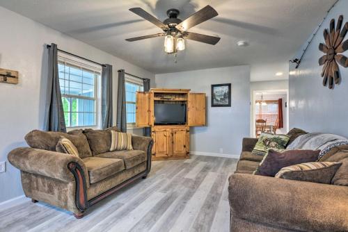 a living room with two couches and a flat screen tv at Table Rock Lake Retreat Less Than 1 Mi to Boat Launch in Golden