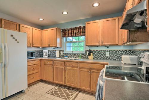 a kitchen with wooden cabinets and a white refrigerator at Table Rock Lake Retreat Less Than 1 Mi to Boat Launch in Golden