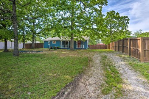 a yard with a blue house and a fence at Table Rock Lake Retreat Less Than 1 Mi to Boat Launch in Golden