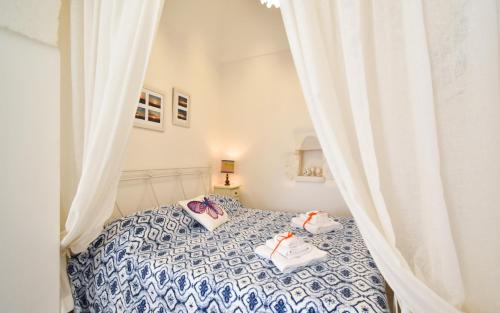Postel nebo postele na pokoji v ubytování La Casetta di Nonna Luccia by Rentbeat