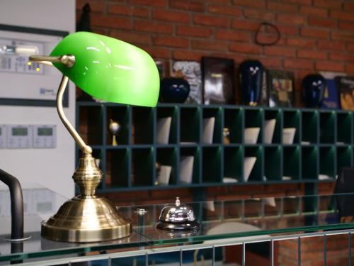 a green lamp sitting on top of a counter at About Sololaki in Tbilisi City