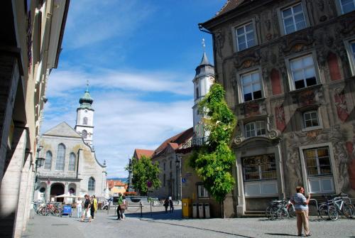a street in a city with two tall buildings at Hotel Garni Brugger in Lindau