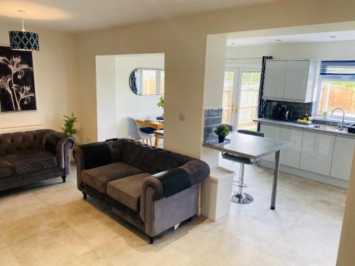 a living room with a couch and a table at Modern Family Home with Off-Road Parking in Cardiff