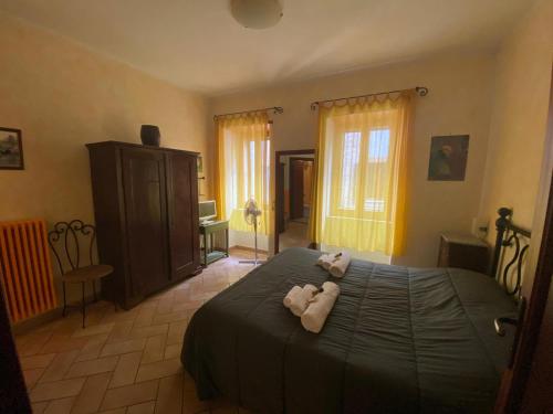 a bedroom with a bed with two stuffed animals on it at Affittacamere La Magica Torre in Pitigliano