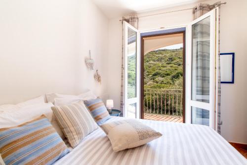 Postel nebo postele na pokoji v ubytování Residence L'Olivastro