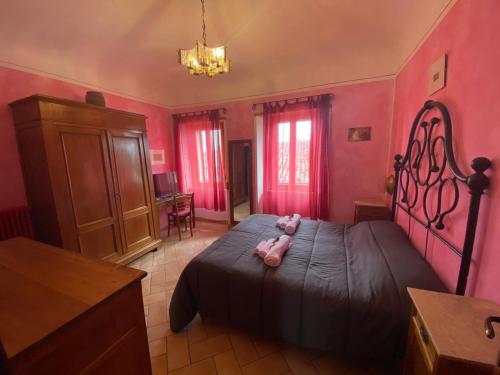 a bedroom with a large bed and a large window at Affittacamere La Magica Torre in Pitigliano