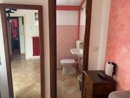a bathroom with a toilet and a sink at Affittacamere La Magica Torre in Pitigliano