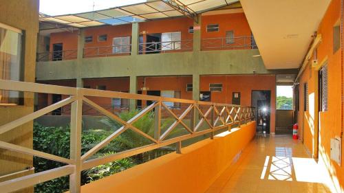 a hallway of a building with a balcony with plants at Salata Hotel in Jardinópolis