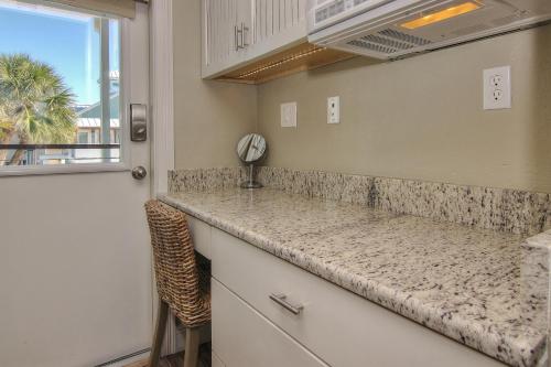 a kitchen with a counter top and a window at Bungalow Beach Place 7 in Clearwater Beach