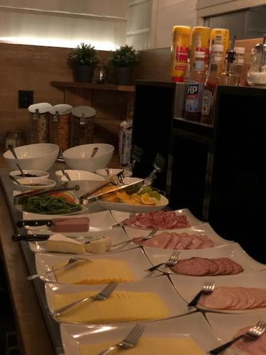 a table with many plates of food on it at Hotel Nordica Strömsund in Strömsund
