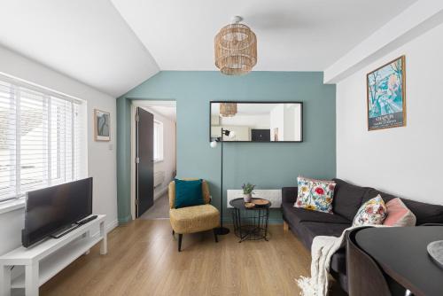 a living room with a couch and a tv at Albany 2 by Black Door Stays in Cardiff