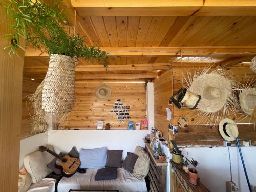 - un salon avec un canapé et une guitare dans l'établissement We surf Morocco BOUTIQUE HOUSE, à Taghazout