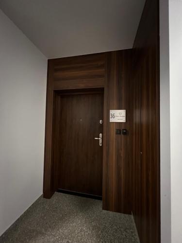 a door leading to a room with a wooden floor at Apartament Poznańska in Suwałki