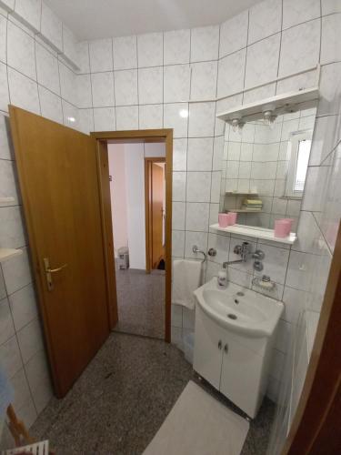 a bathroom with a sink and a toilet and a mirror at Apartment Aida in Visoko