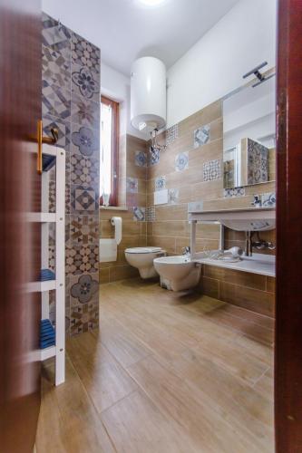 a bathroom with two sinks and two toilets at SanvitoTour - Villa Soffio di Mare in San Vito lo Capo