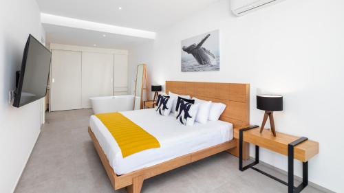a bedroom with a large bed and a television at Amazing &Totally New!!! Aria Ocean Condo 306 by Kivoya in Nuevo Vallarta